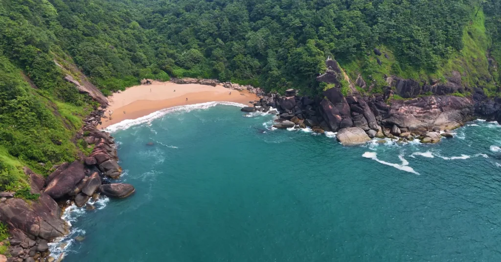 Natural rock pools at Butterfly Beach during low tide with marine life